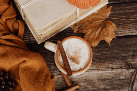 Hot spicy coffee and pile of old books on wooden backgroundの写真素材