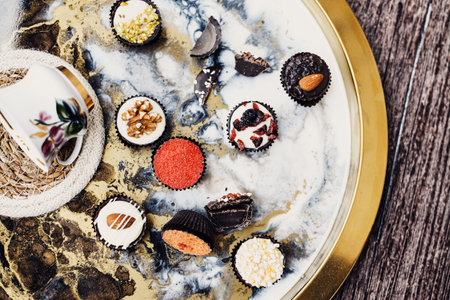 Various small chocolate candies on vintage backgroundの写真素材