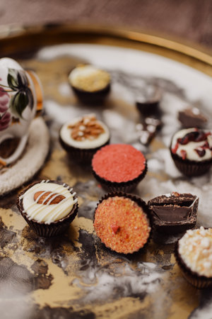 Various small chocolate candies on vintage backgroundの写真素材