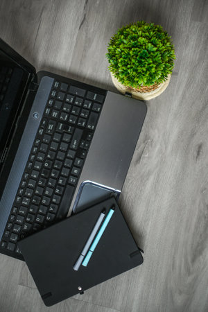 <p>Workspace in the office, laptop, notebook, coffee and decorations</p>の写真素材