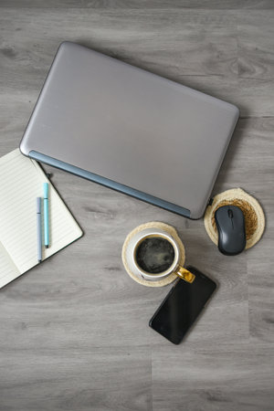 <p>Workspace in the office, laptop, notebook, coffee and decorations</p>の写真素材