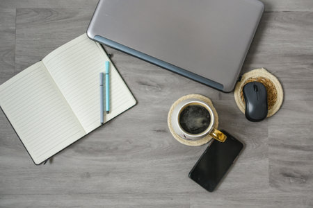 <p>Workspace in the office, laptop, notebook, coffee and decorations</p>の写真素材