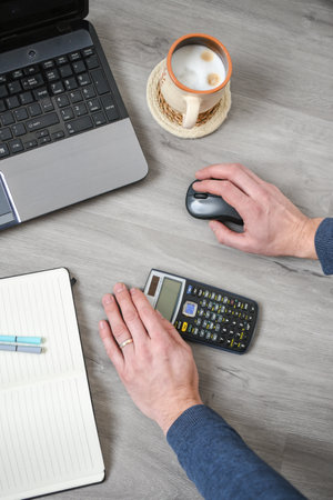 person using laptop, working and counting money in the officeの写真素材