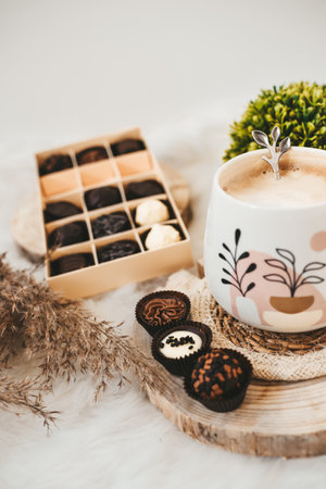 White coffee and chocolate candies on white background indoorsの写真素材