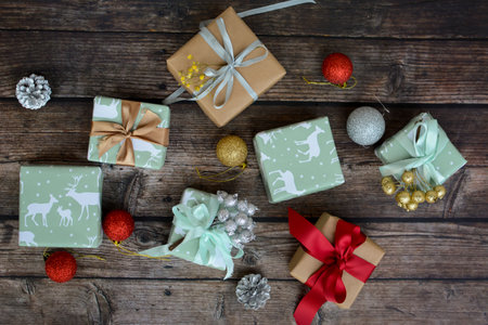 Small Christmas presents and decorations on dark wooden background