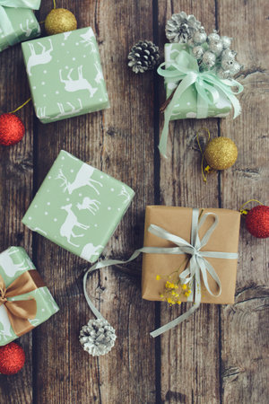 Small Christmas presents and decorations on dark wooden backgroundの写真素材