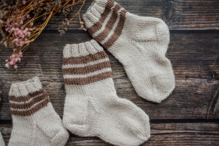 Brown baby socks made of soft cotton yarn, o dark wooden backgroundの写真素材