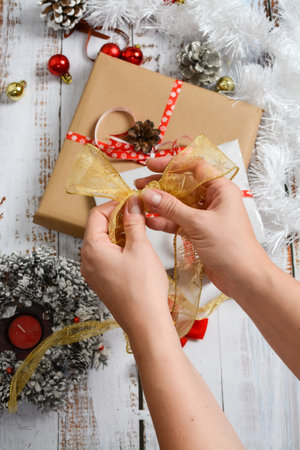 Wrapping small Christmas presents, on white backgroundの写真素材