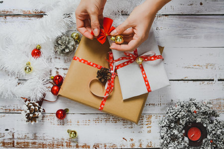 Wrapping small Christmas presents, on white backgroundの写真素材