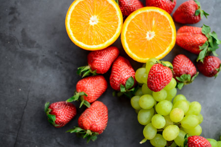 Fresh fruits on a dark background, top view, copy space.の写真素材