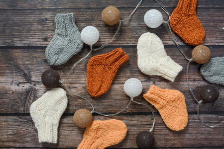 Knitted woolen socks on a wooden background. Knitted woolen socks.