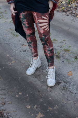 Legs of a young girl in leggings and white sneakersの写真素材