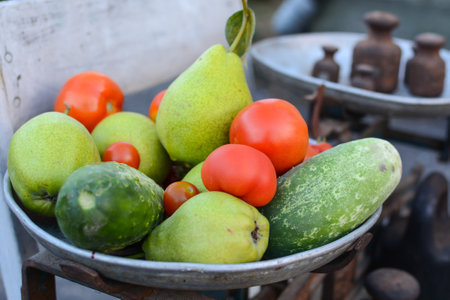 Fresh fruits and vegetables in a basket on a market stall, selective focusの写真素材