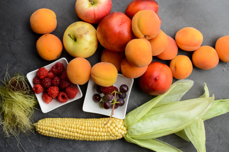 Composition with fresh fruits and vegetables on grey background, top viewの写真素材