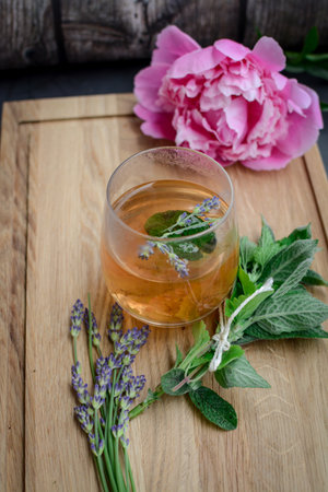 Herbal tea with mint and lavender flowers on a wooden backgroundの写真素材