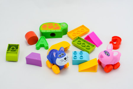Plastic building blocks and toys on a white background, close-upの写真素材