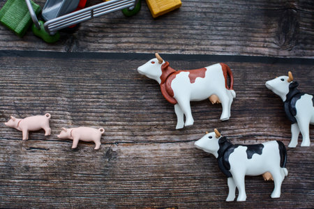 Group of toy cows on a wooden background. Selective focus.の写真素材