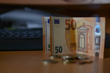 Euro banknotes and coins on the table in the office. Business concept