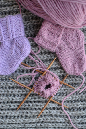 Knitting needles and knitted socks on grey background, closeupの写真素材