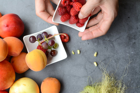 Fresh fruits and berries on grey table, top view. Healthy eating conceptの写真素材