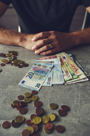 Man counting euro banknotes and coins, closeup. Man counting moneyの写真素材