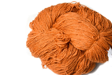 Ball of orange yarn isolated on white background. Top view. Copy space.の写真素材