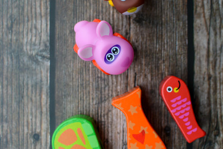 Funny toys on wooden background, closeup, top view.