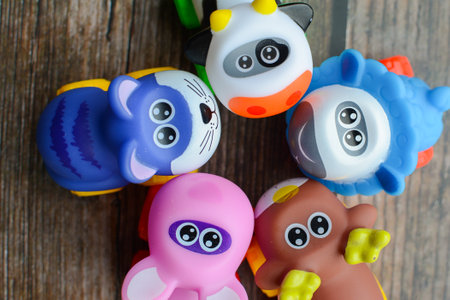 Funny toys on wooden background, closeup, top view.