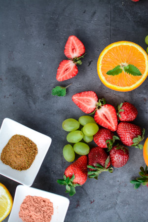 Healthy eating and dieting concept. Assortment of fresh fruits and berries on black background.の写真素材