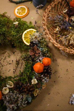 Decorated Advent wreath made of moss, dried flowers and fruitsの写真素材