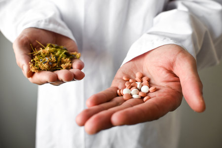 Close up of man's hands holding a handful of pills and herbsの写真素材