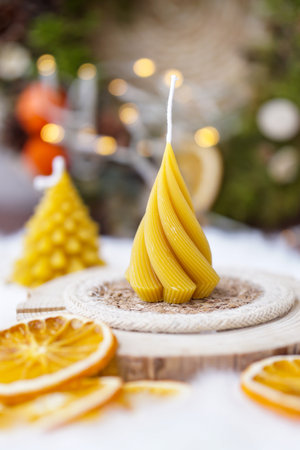 Christmas candles in the shape of a Christmas tree on a wooden boardの写真素材
