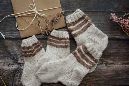 Woolen socks and gift box on a dark wooden background.の写真素材