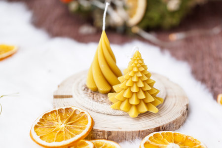 Christmas decoration with candles and dried orange on wooden background, selective focusの写真素材