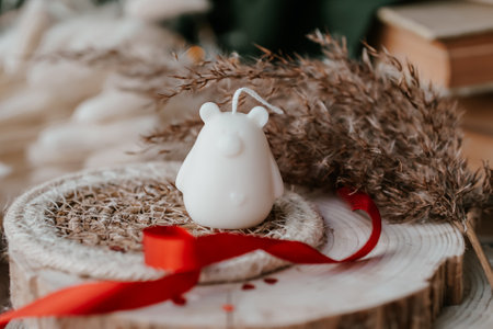 Bear shaped soy wax candles in the dark room, vintage decorations aroundの写真素材