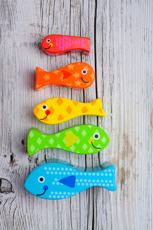 Colorful wooden toys for kids on a white wooden background. Selective focus.の写真素材