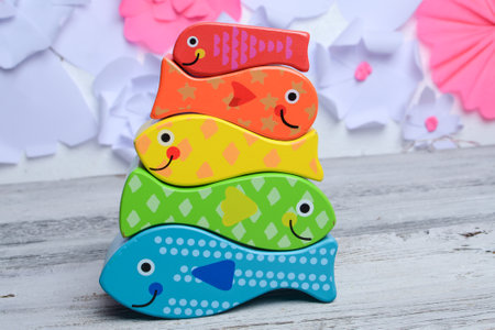 Colorful wooden toys for kids on a white wooden background. Selective focus.の写真素材