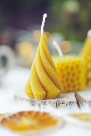 wax candles in the shape of a Christmas tree on a wooden backgroundの写真素材