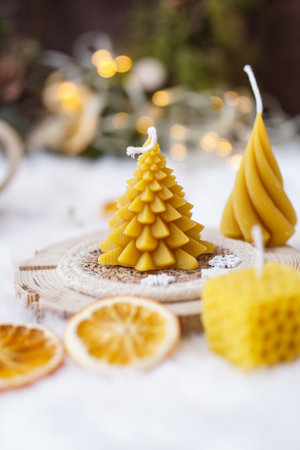 Christmas decoration with candles and dried orange slices on a wicker standの写真素材