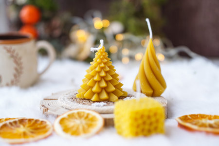 Christmas tree made of yellow bee wax on wooden background, selective focus.の写真素材