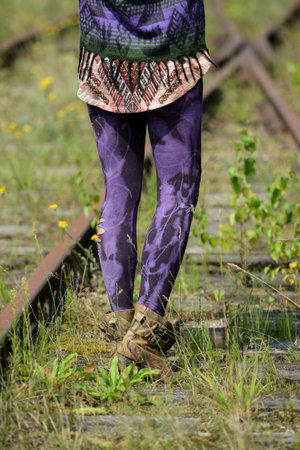 Close up of legs of woman walking on railway track. Selective focusの写真素材
