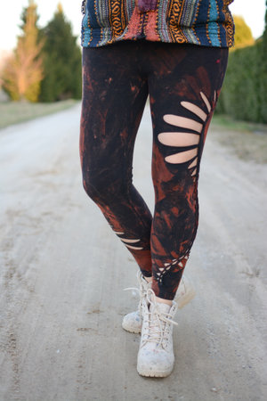 Legs of a young woman in black leggings on the roadの写真素材