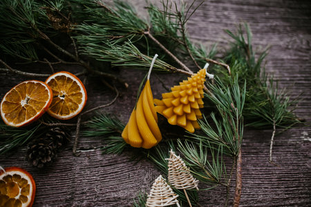 Christmas decoration with fir branches, candles and dried oranges on wooden backgroundの写真素材
