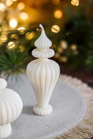Christmas candles on the background of a Christmas tree and bokehの写真素材