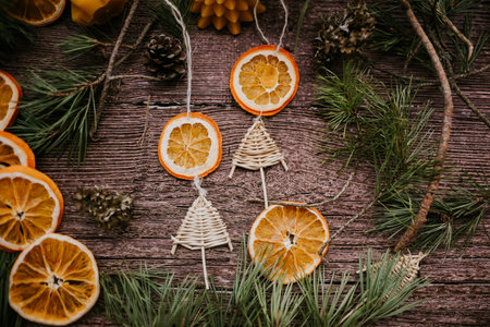 Christmas decoration with dried orange slices and pine branches on rustic wooden backgroundの写真素材