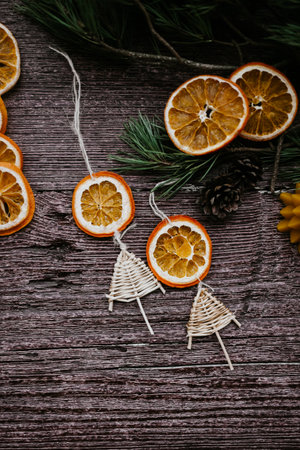 Christmas decoration with dried oranges and fir branches on a wooden background.の写真素材