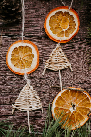 Christmas decoration with dried oranges and fir branches on rustic wooden backgroundの写真素材