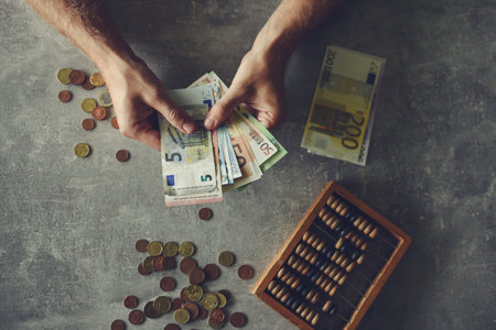 Man counting money on grey background, closeup. Business and finance conceptの写真素材