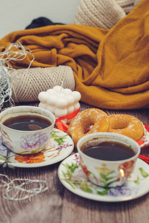 Still life with cup of coffee and donuts on a wooden tableの写真素材