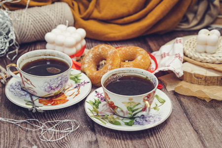 Two cups of coffee and donuts on a wooden background. Breakfast.の写真素材